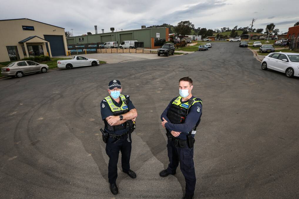 BAD BEHAVIOUR: Senior Constable Owen Clarke and Constable Mark Horne stand near burnout tracks on Chisholm Court in Wodonga. Picture: JAMES WILTSHIRE