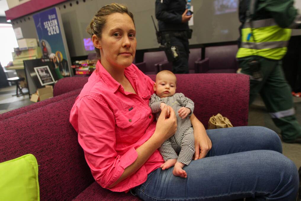 SMOKE CONCERNS: Laura Hogg, pictured with Audrey, 12 weeks, successfully defended her home at the weekend but left amid concerns for smoke haze. Pictures: BLAIR THOMSON