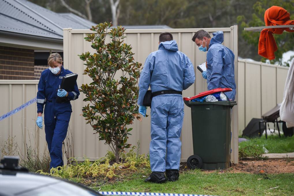 EXAMINATION: Forensic police officers outside the Peeler Street property in Wodonga, the morning after Twizere Nyiratingabandi's death in April 2020. 