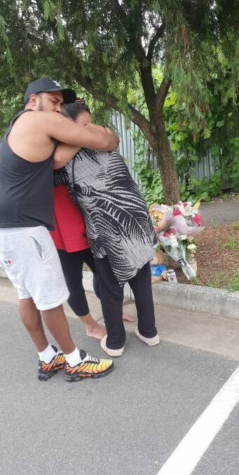 TRIBUTE: Duwayne Johnson's family at the site of his murder. 