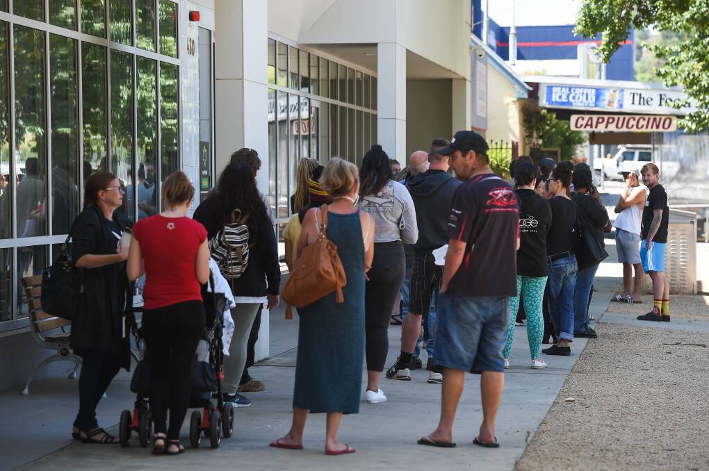 LINE UP: Crowds gather outside the Albury Centrelink offices in March after governments announced the closure of non-essential business due to coronavirus. 