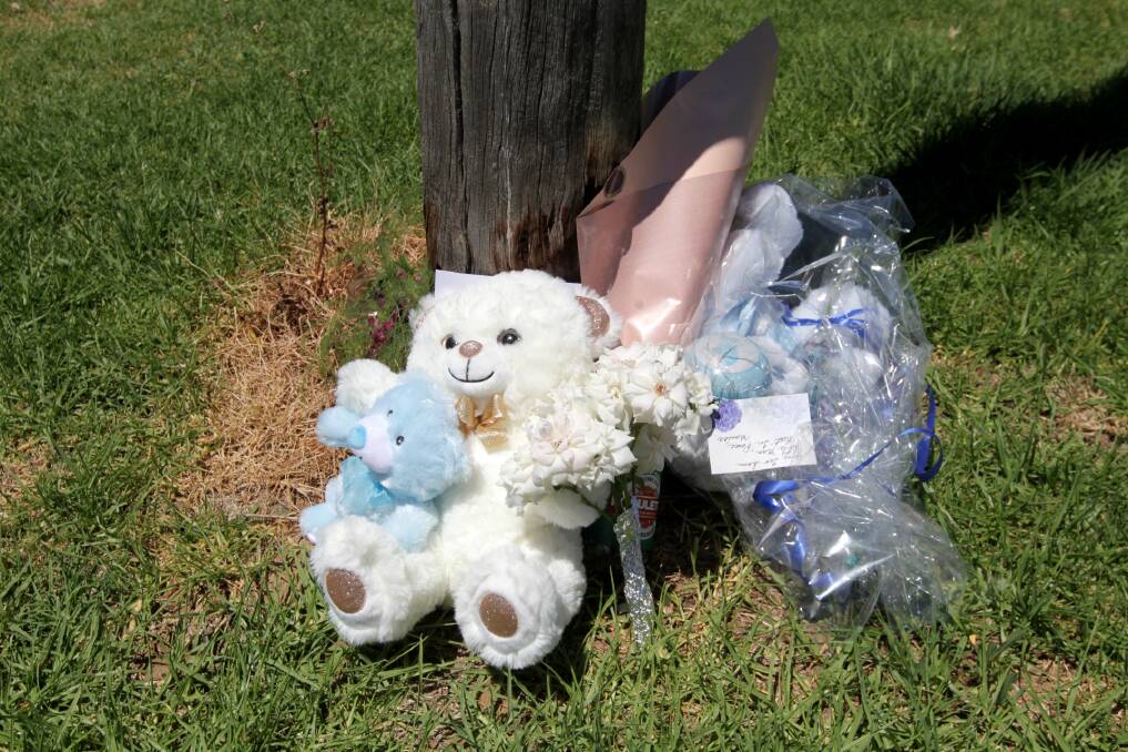 GRIEVING: People have left plush toys, flowers and messages for the three-month-old boy outside his home after Wednesday night's tragic discovery. 