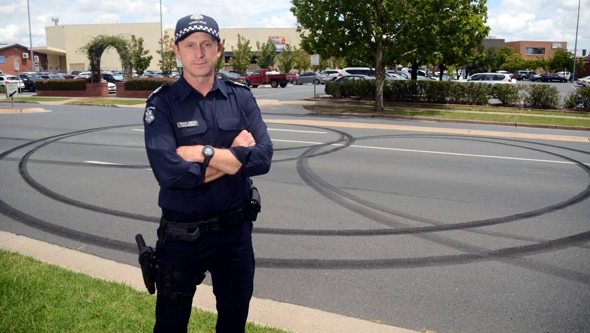SCENE: Senior Sergeant Shane Martin with tyre marks left by the offender. Picture: BLAIR THOMSON