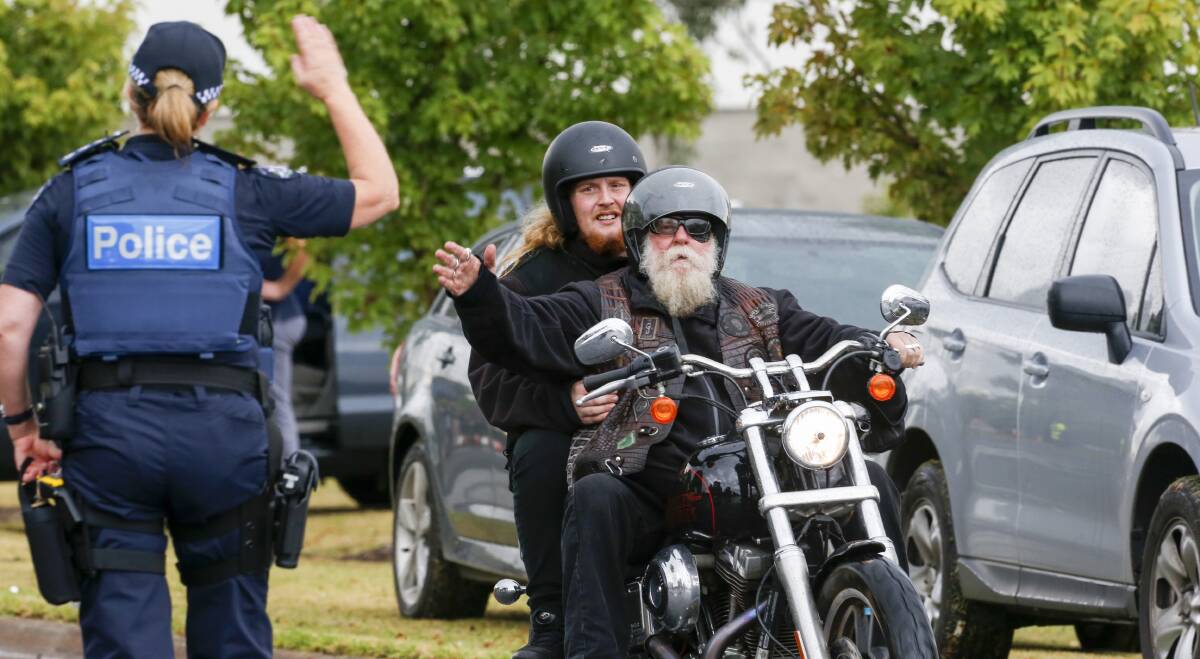 OPERATION: Two bikies are directed through a roadblock in Wodonga on Monday after leaving the Gypsy Jokers clubhouse in Kendall Street. 
