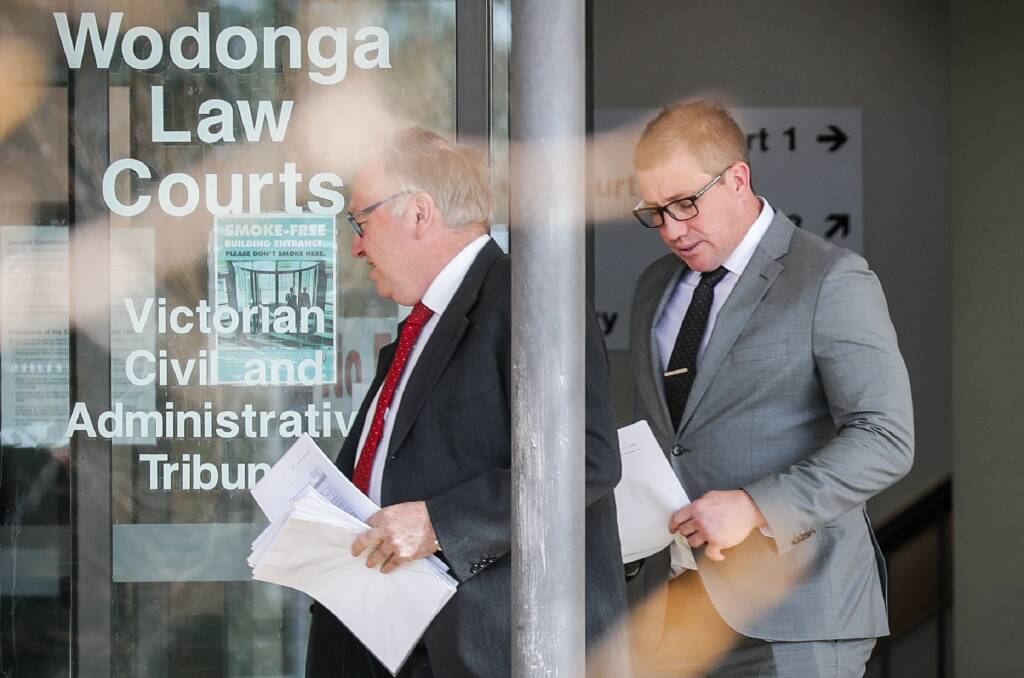 APOLOGY: Brad Thompson, pictured right in a grey suit outside the Wodonga Magistrates Court, spoke directly to the victim of his violent attack on Thursday. 
