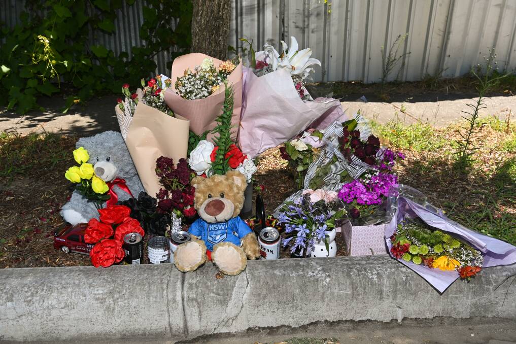 GROWING TRIBUTE: Flowers and other items have been left on Woodland Street in Wodonga since last weekend's shooting of Duwayne Johson. Picture: MARK JESSER