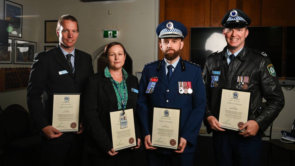 Detective Senior Constable Rowan Weekley, Detective Senior Constable Kelly Johnson, Inspector Scott Trewhella and Senior Constable Michael Skillicorn with their citations for the firearms investigation. Picture by Mark Jesser