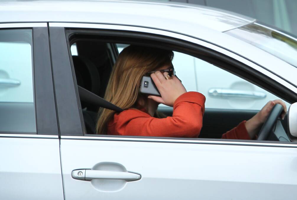 Plain clothes police catch 30 drivers on phone in city’s main street