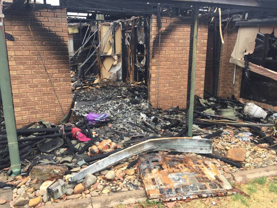 BURNT OUT: Personal items, including a damaged toy and girl's backpack were visible in the home after the fire, which was allegedly deliberately lit. 