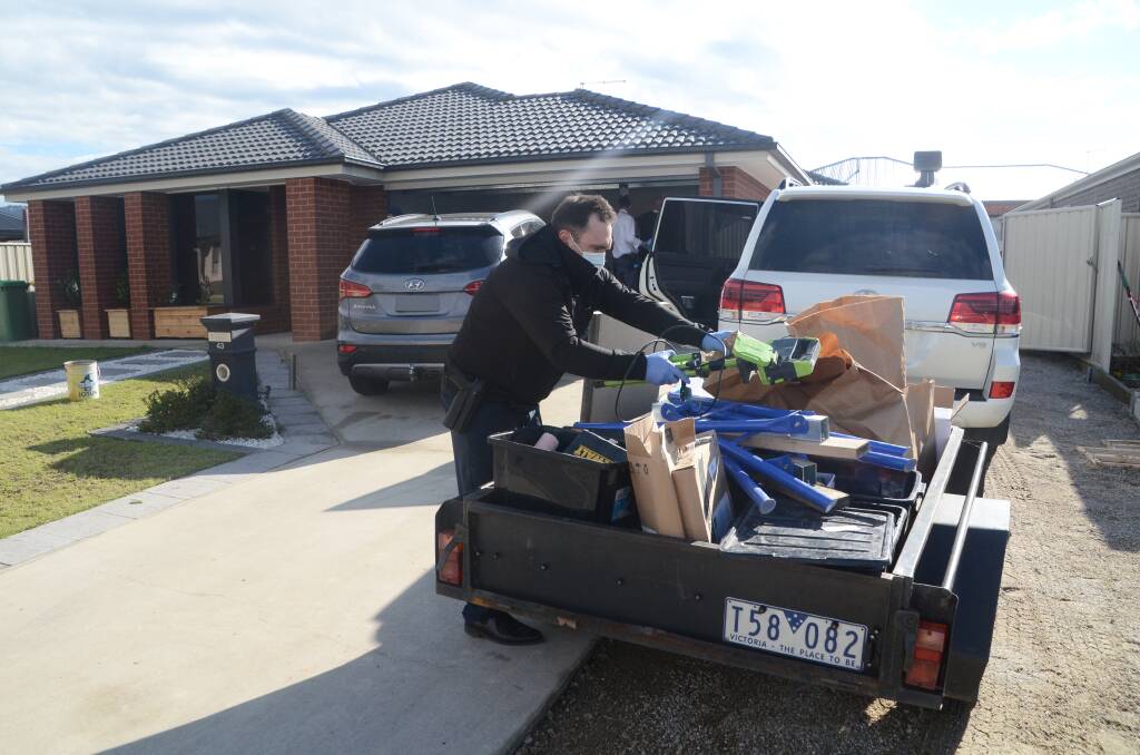 HUGE HAUL: Police loaded up several vehicles and trailers with suspected stolen property and building supplies following 16 burglaries. A Hyundai, left, appeared similar to one seen on CCTV near a job site. Picture: BLAIR THOMSON