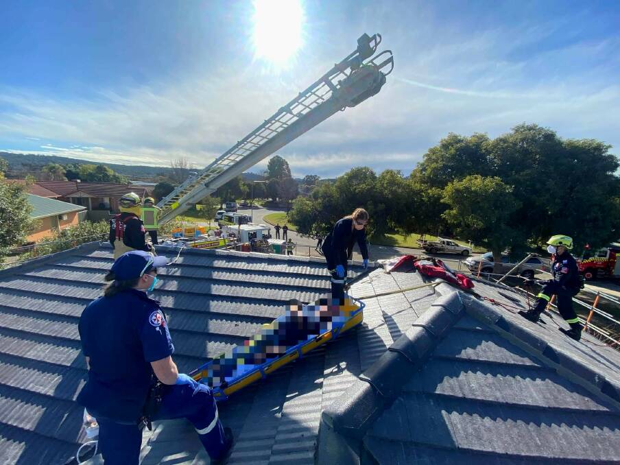 LOWERED: The man had to be taken down from the roof in the boom of a fire truck. Picture: ALBURY AND BORDER RESCUE SQUAD