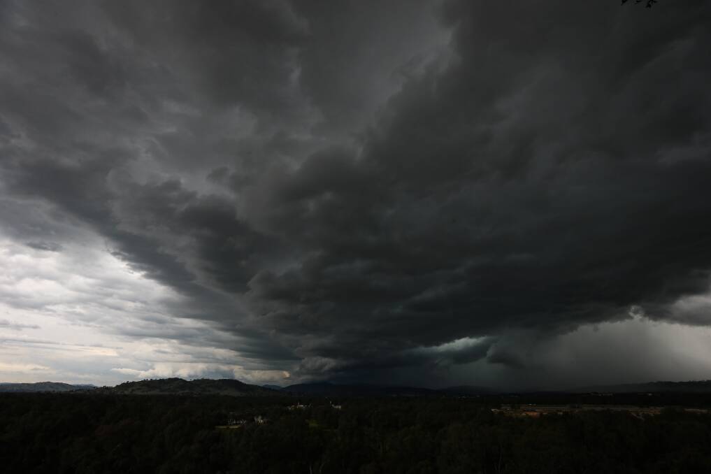 STORM BREWING: Dark clouds formed to the north east of Albury on Saturday night before dumping rain on the city, with more forecast in the coming week. Picture: JAMES WILTSHIRE