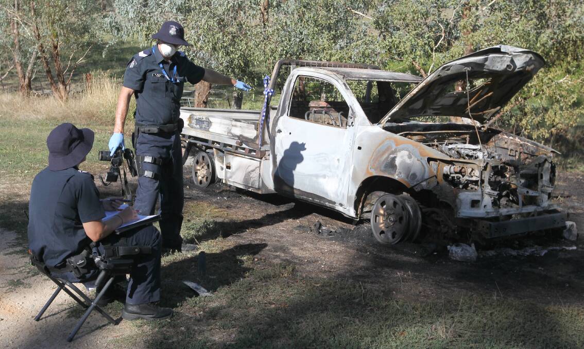 GUTTED: Wodonga forensics officers examine Michael Bartel's burnt-out vehicle in Bonegilla on Thursday morning. The car was found about 20 kilometres from his Kiewa home. Pictures: BLAIR THOMSON