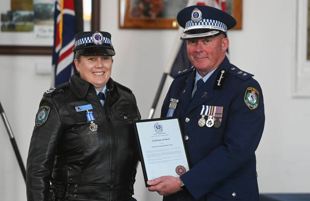 Senior Constable Bree Furze received a certificate of merit from Superintendent Paul Smith for assisting a man trapped in a large grain silo. Picture by Mark Jesser