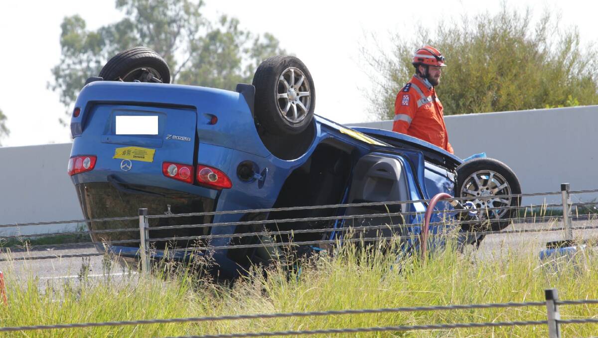Police, paramedics on scene after car rolled on Hume Freeway