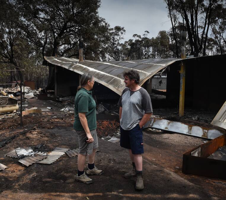 SURVEYING DAMAGE: Gianna and Shane Hogarth with their home, which had almost been completed. 