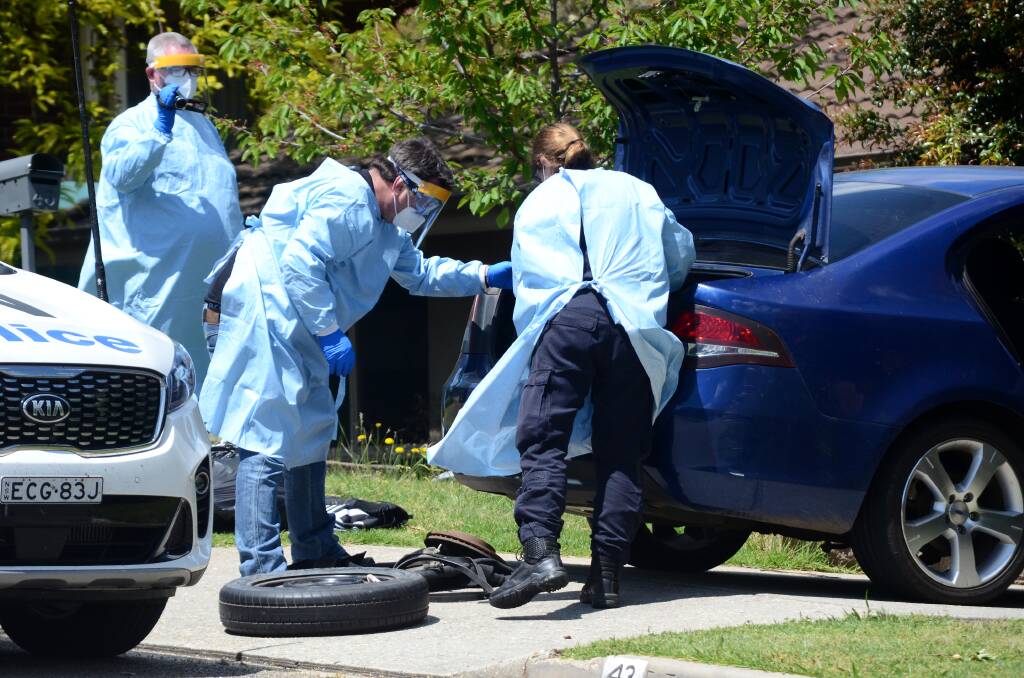 SEARCH: Police used protective clothing while searching the West Albury home. 