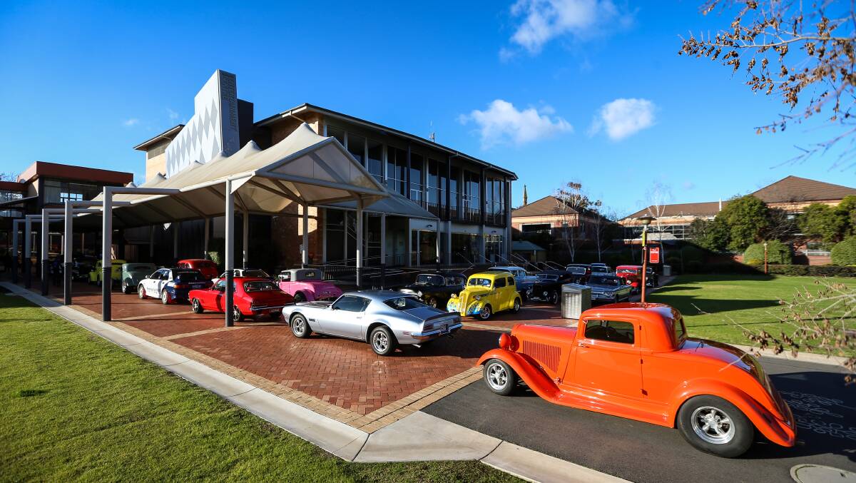 READY TO ROLL: Hot rods and muscle cars outside the centre. 