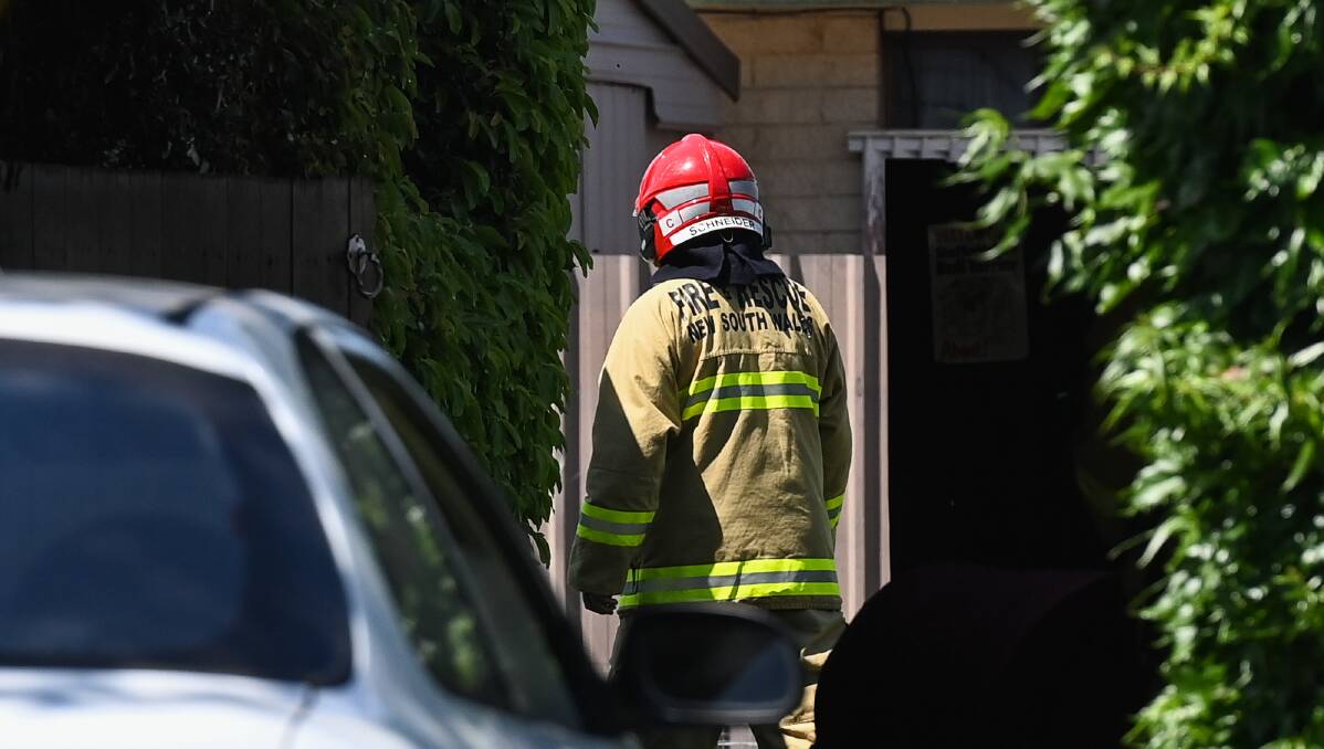 ON SCENE: A firefighter at the Dale Crescent home in Lavington on Wednesday afternoon. The cause of fire inside a bedroom is being investigated. Picture: MARK JESSER