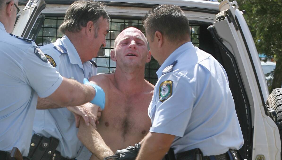 KILLED: Christopher Quirk, pictured during an arrest in 2008, died after being stabbed in an artery. 