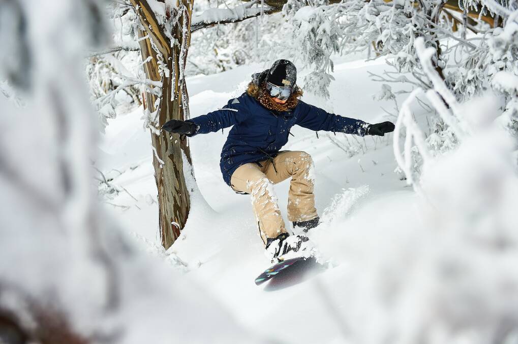 ACTION: Snowboarder Lauren Stavely hitting the slopes at Mt Buller. 