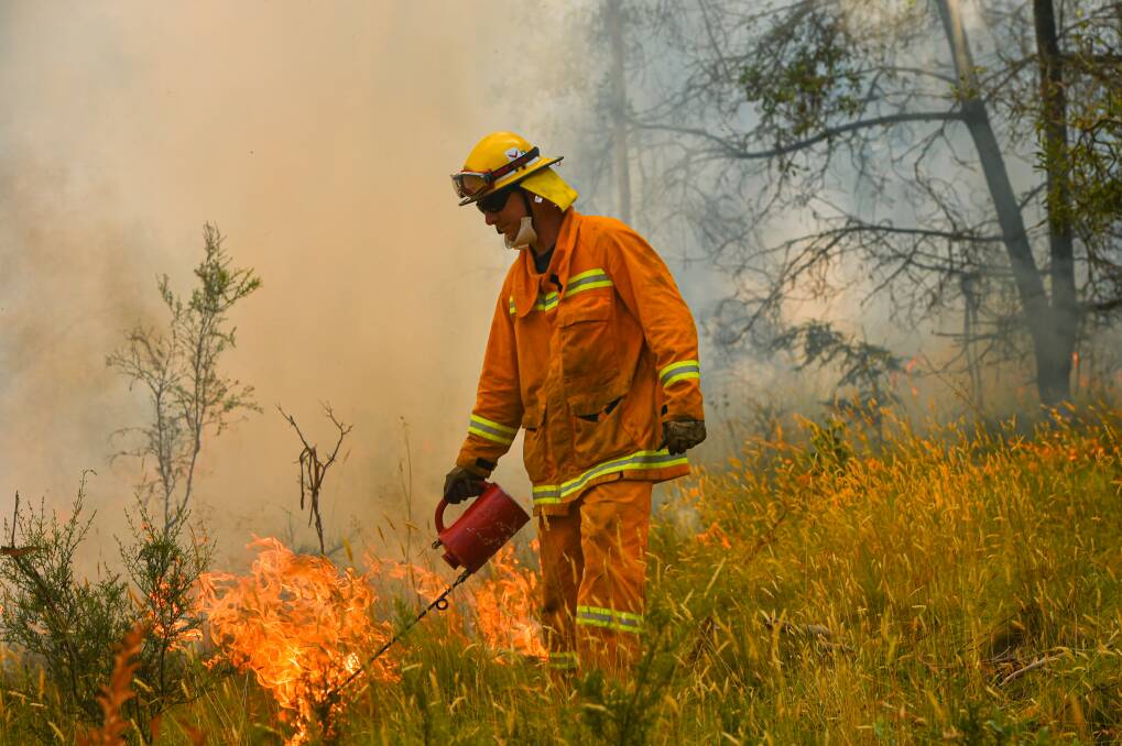 ALIGHT: Controlled burns west of Corryong on Tuesday. Picture: JASON EDWARDS