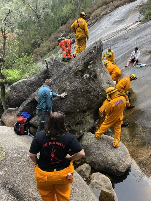 RESCUE: Firefighters and SES volunteers assist the injured man on Sunday. 