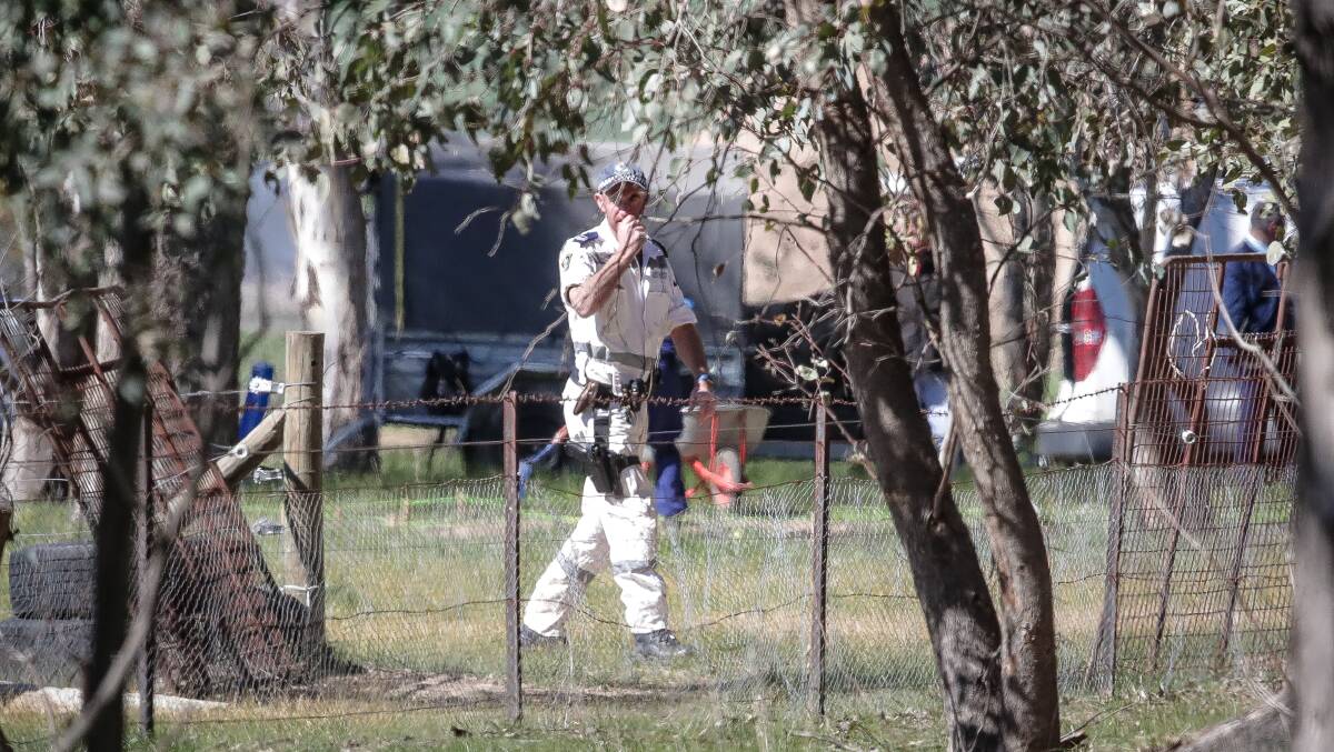 SEARCH: A police officer during the search at Gerogery last week. 