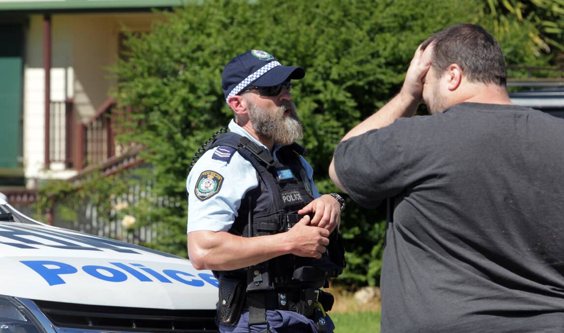 ON SCENE: A man speaks to a police officer outside the Church Street home in Corowa on Thursday. Officers found the body of a three-month-old boy at the home the previous night and arrested a 40-year-old mother, who was later released. Pictures: BLAIR THOMSON