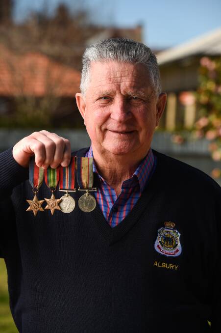MISPLACED: Graham Docksey with medals belonging to Hilton Charles Burrows. The medals were recently handed in to the Albury RSL. Picture: MARK JESSER