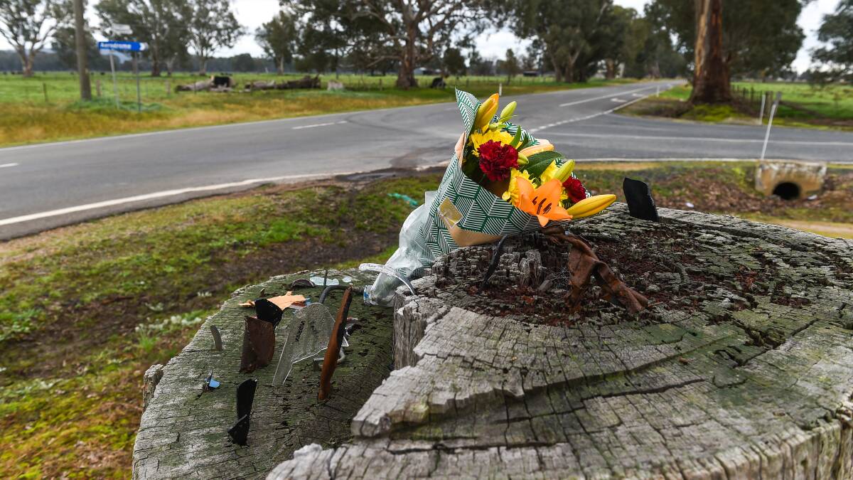 TRIBUTE: Flowers left near the scene of the crash on Greta Road, near the airport, for the two late men. 