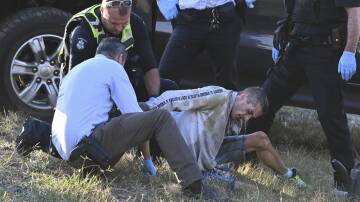 Joel Butler is restrained by police after three to four hours of dangerous driving in a stolen vehicle. File photo