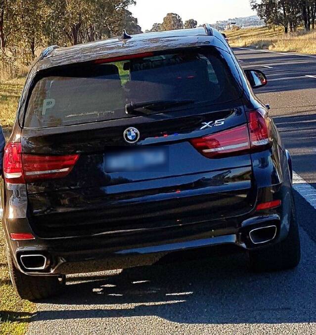 STOPPED: The second X5 on the side of the highway. 