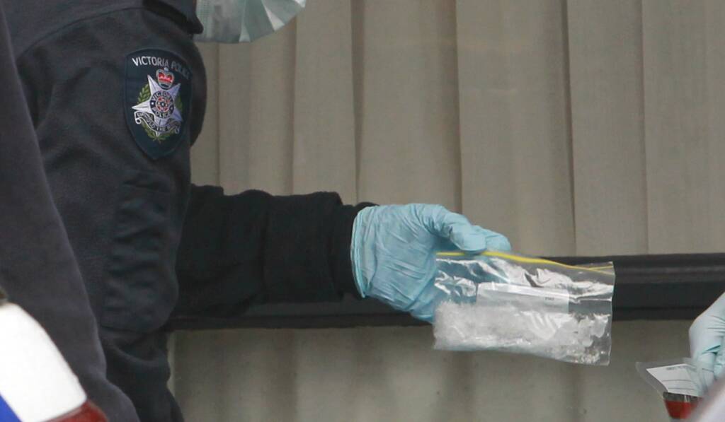 RAID: Wodonga police with a large bag of ice seized at a hotel. 