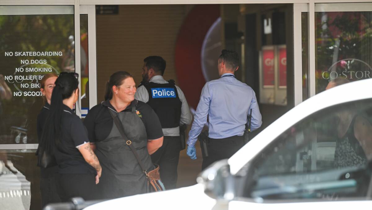 Police inspect the scene of Thursday afternoon's smash and grab at Prouds in Wangaratta. Picture by Mark Jesser