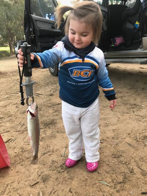LITTLE BEAUTY: Young Indi, 2, caught her very first trout while out fishing with her grandparents on the weekend.