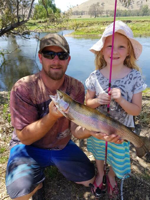 BEST PRESENT: Kayla George with a 55cm rainbow trout caught on worms in the Mitta River with her Christmas fishing rod. Pictured with dad Shane.