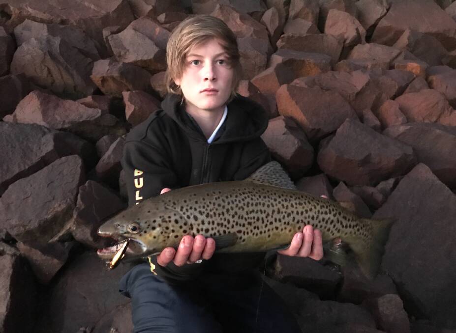 TOP CATCH: John Moncrief with the good-sized brown trout he caught below the Hume Weir wall. It was landed on a spawning brown, five-centiemtre bullet lure.