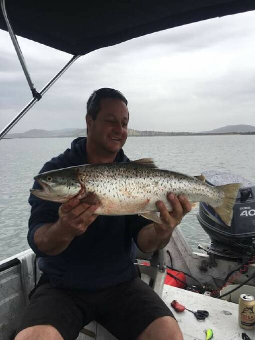 NICE CATCH: Matt Giggins pictured with the 63cm trout he caught at Lake Hume recently.