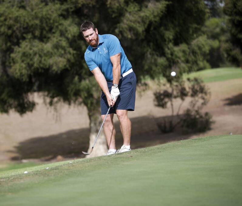 Jason Akermanis practices his chipping at Commercial Golf Club recently. Picture: JAMES WILTSHIRE