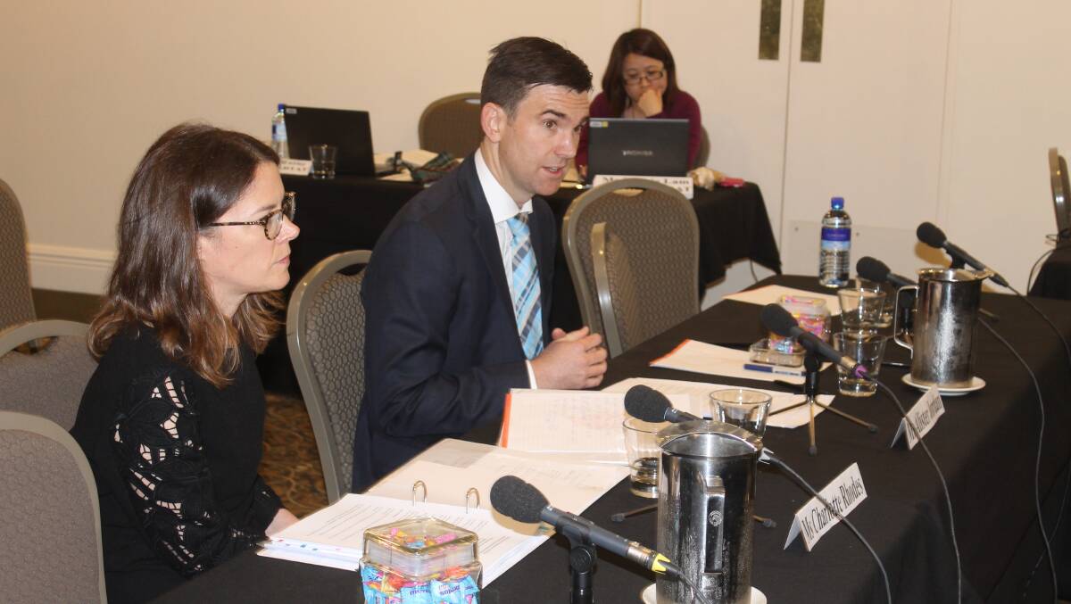 Coles director Alister Jordan and Dairy general manager Charlotte Rhodes answer questions at the Senate inquiry.
