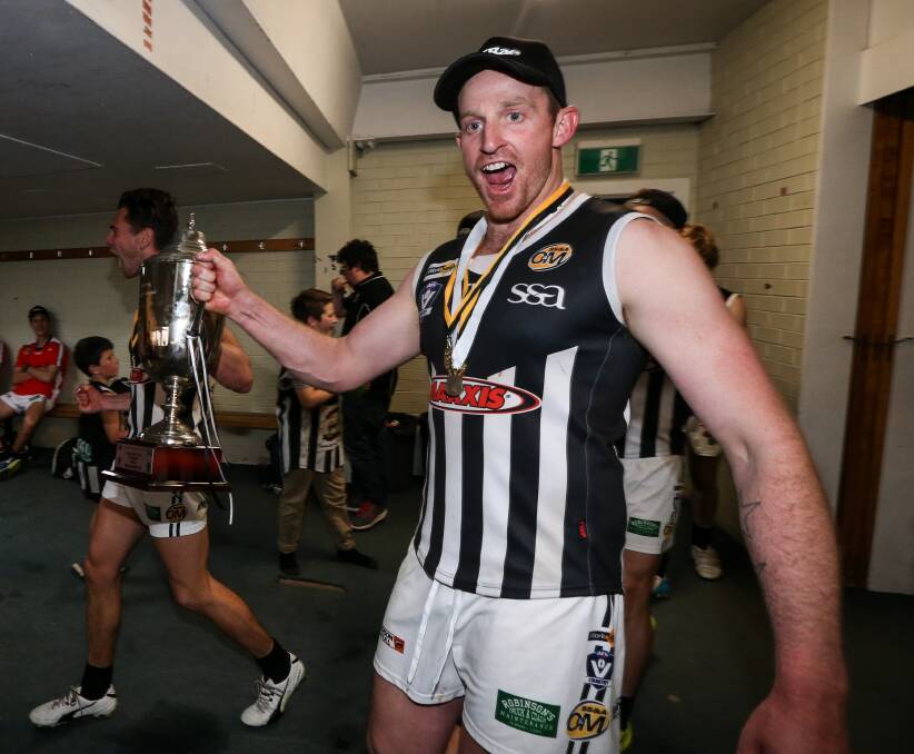 YOU BEAUTY: Michael Newton with the 2017 O&M premiership cup after the Magpies' win over Albury.