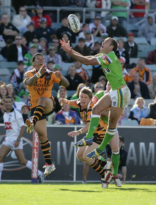 FLYING HIGH: Adrian Purtell in action for Canberra Raiders against Wests Tigers in 2008 (top).