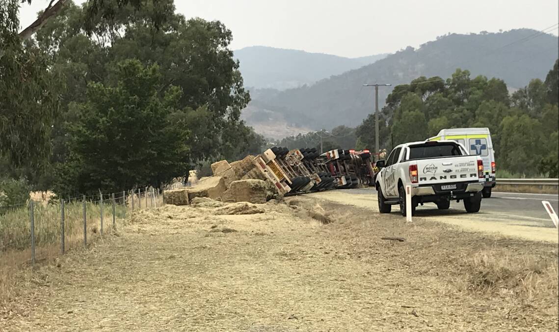The Murray Valley Highway has been closed in both directions, near Tallangatta, after a hay truck rolled on Wednesday afternoon. 
