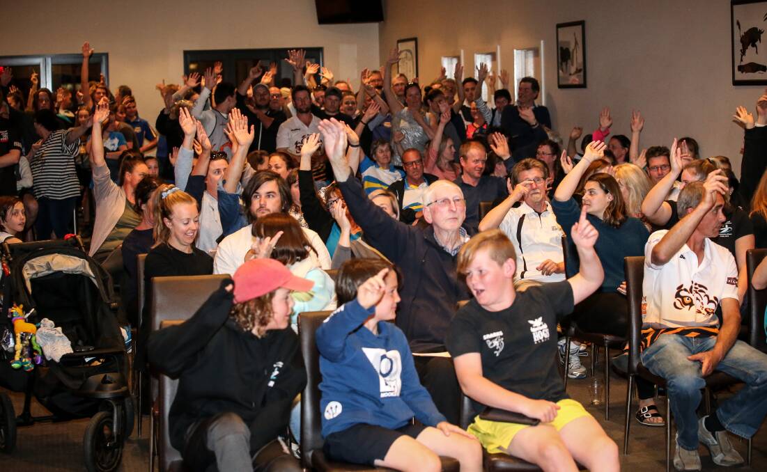 Hands up: Arms are raised in support of a call to boycott Albury-Wodonga's pools over lane hire fees. Picture: JAMES WILTSHIRE