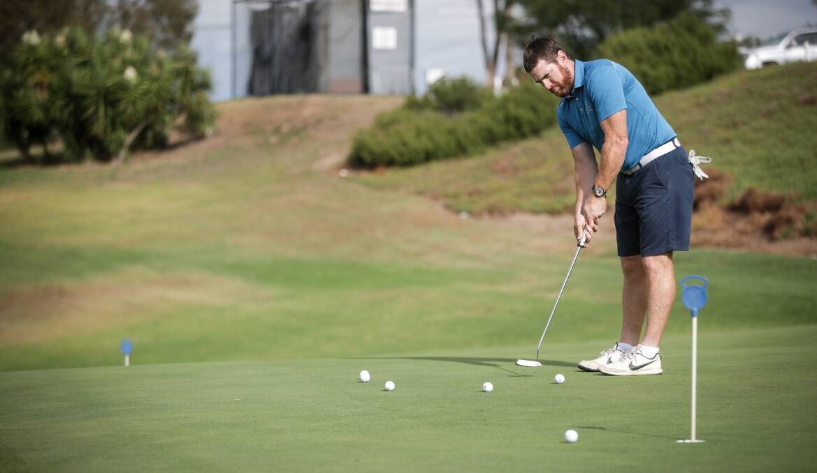PRACTICE MAKES PERFECT: Former North Albury coach Jason Akermanis works on his putting at Commercial Albury golf club. Picture: JAMES WILTSHIRE