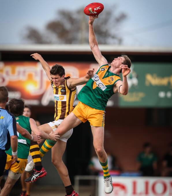 HOP TO IT: North Albury ruckman John Willis leaps high to win a hitout against Wangaratta Rover Matt Wright at Bunton Park on Saturday. Pictures: JAMES WILTSHIRE