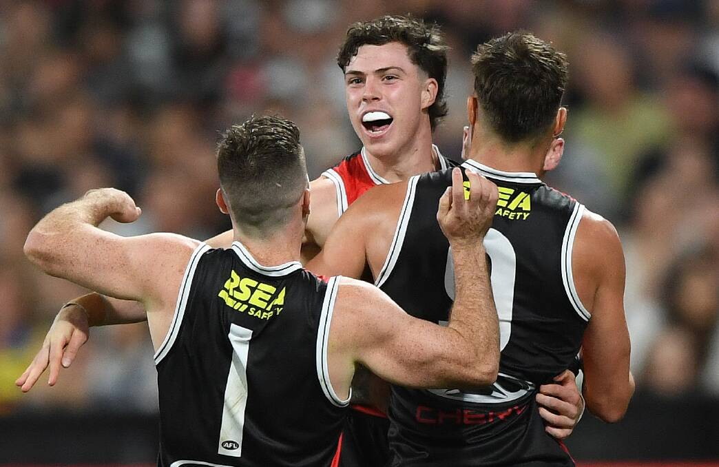 St Kilda teammates congratulate Darcy Wilson (centre) on his first AFL goal. Picture by AAP