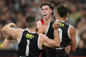 St Kilda teammates congratulate Darcy Wilson (centre) on his first AFL goal. Picture by AAP