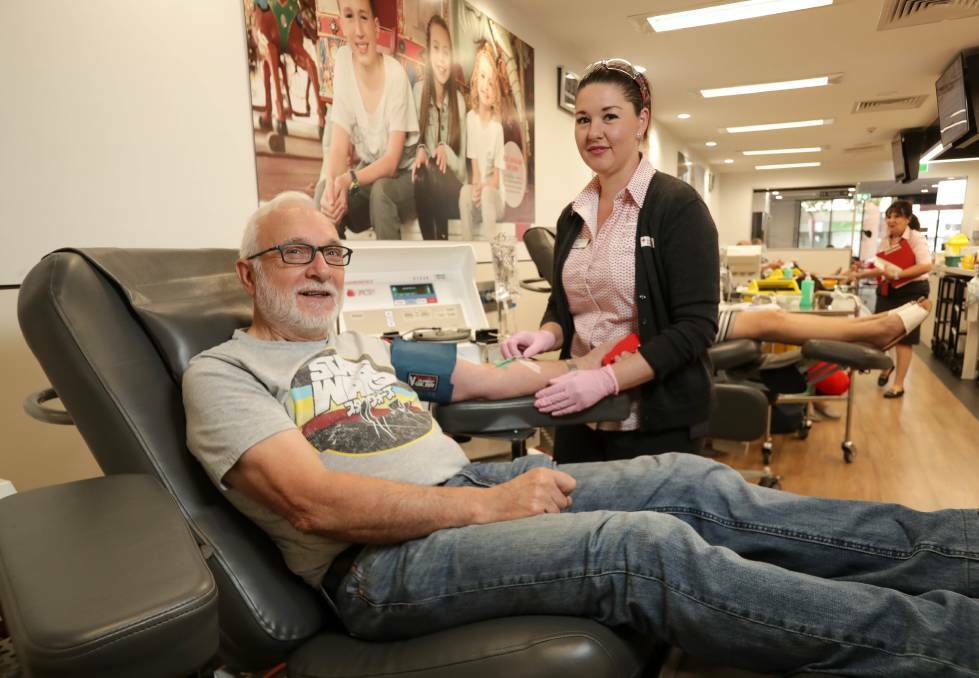 LEGEND: John Cretan from Lavington gives his 270th blood donation at the Albury Blood Donor Centre, with session leader Tanya Cannizzaro. Picture: JAMES WILTSHIRE